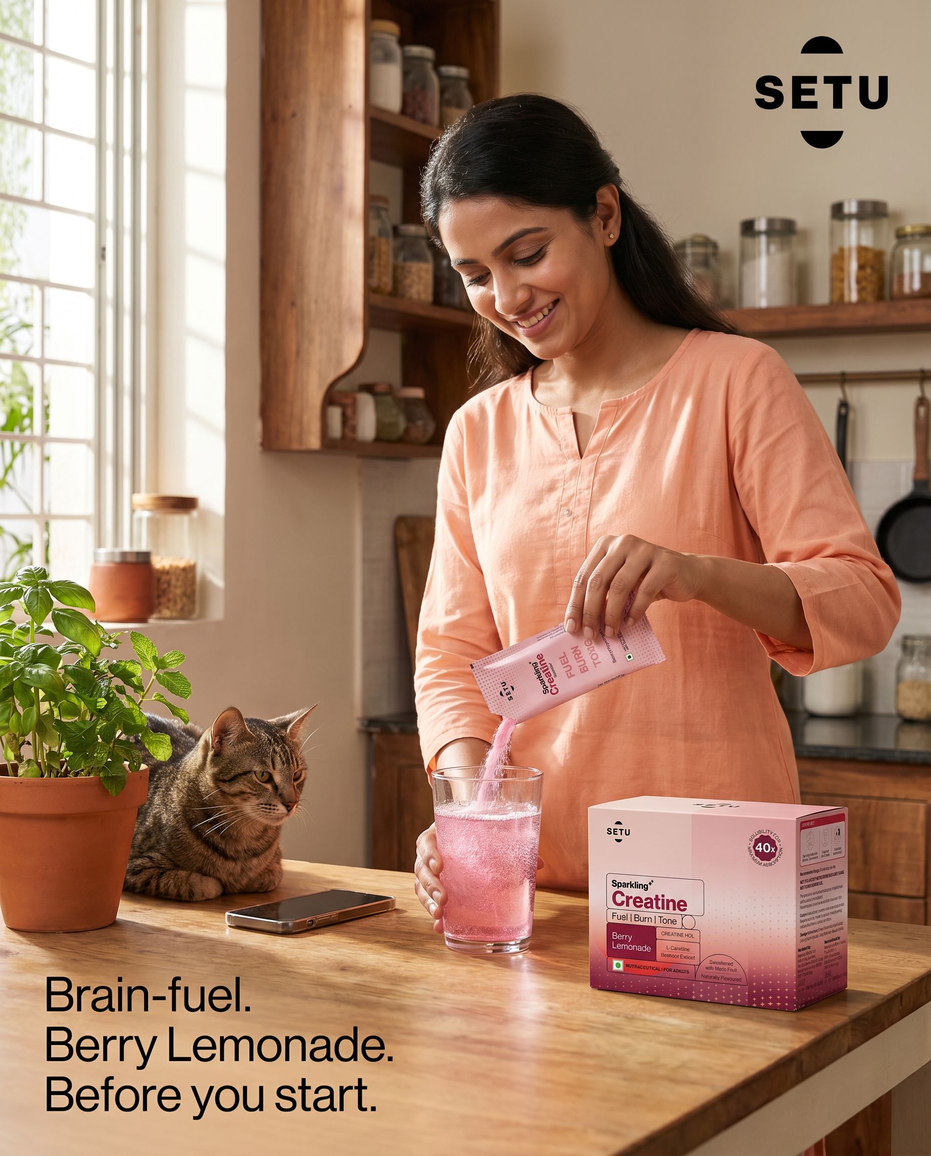 Woman pouring SETU Sparkling Creatine sachet into a glass in a sunlit Indian kitchen — morning ritual