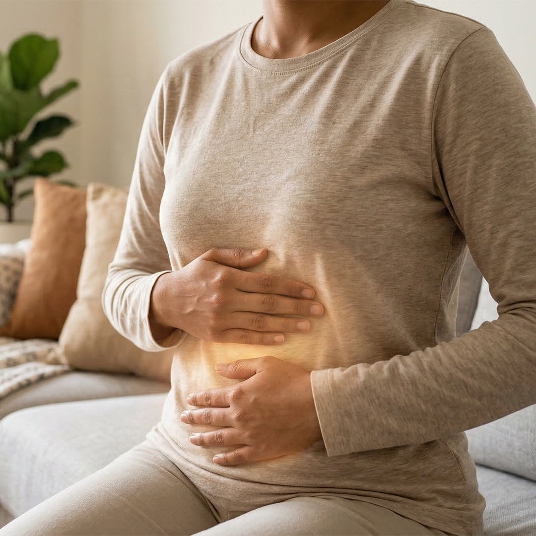 Real woman holding her stomach — illustrating the digestive discomfort common with monohydrate creatine